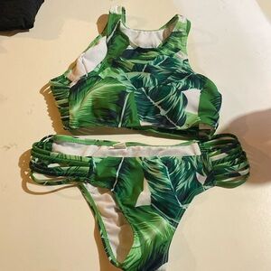 Woman’s swimsuit, green leaves, straps on sides of both pieces, NWOT.